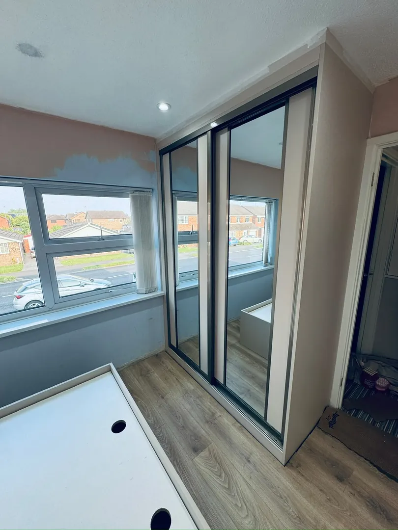 After: Spare bedroom transformed with a corner sliding mirror wardrobe