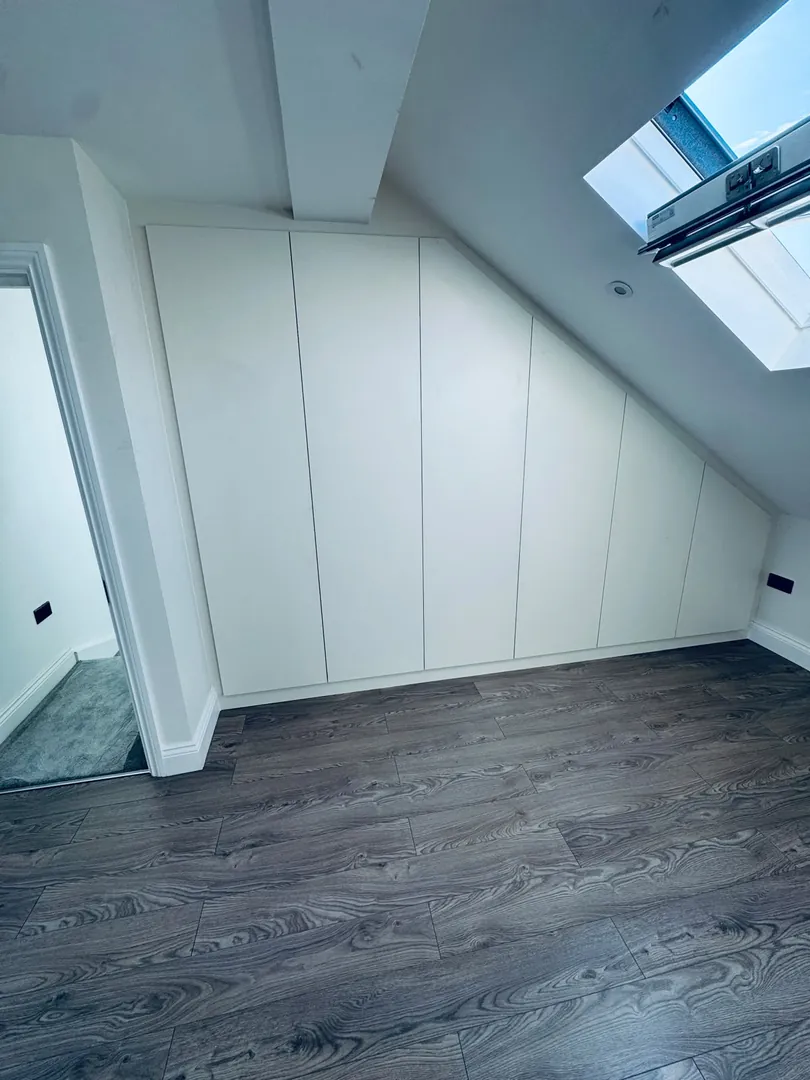 After: Awkward loft eaves turned into a seamless fitted wardrobe
