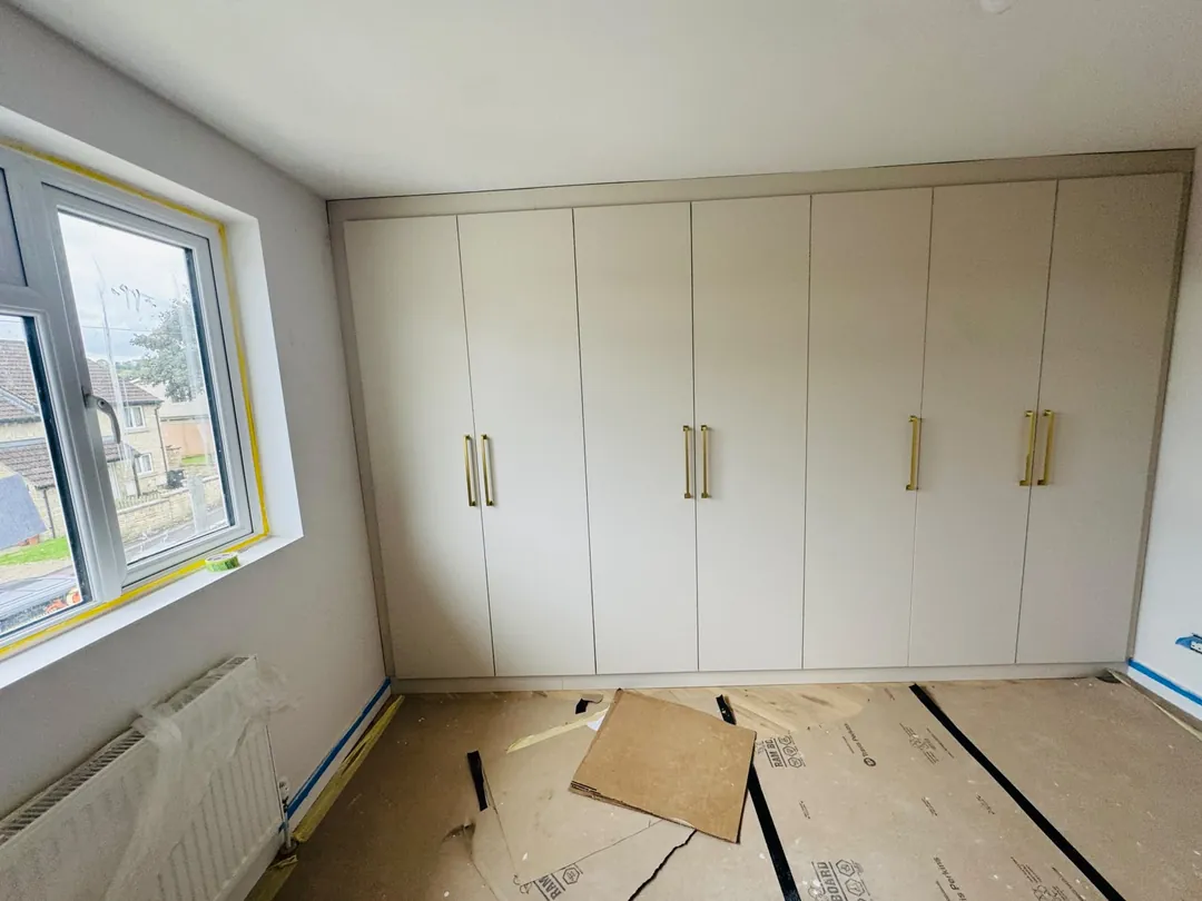 After: Empty bedroom fitted out with full-height wardrobes